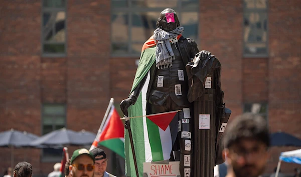 Stickers and Palestininan flags cover a statue of George Washington at an encampment by students at George Washington University on Tuesday, April 30, 2024, in Washington. (AP)