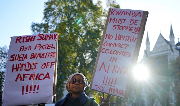 A protester stands outside the Supreme Court in London, on November 15, 2023. (AP)