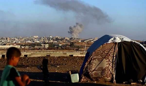 Smoke rises following an Israeli airstrike on buildings near the separating wall between Egypt and Rafah, southern Gaza Strip, Tuesday, May 7, 2024. (AP)