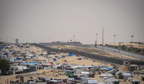 Palestinians displaced by the Israeli air and ground offensive on the Gaza Strip walk through a makeshift tent camp in Rafah, on the border with Egypt Gaza, Friday, May 10, 2024. (AP)