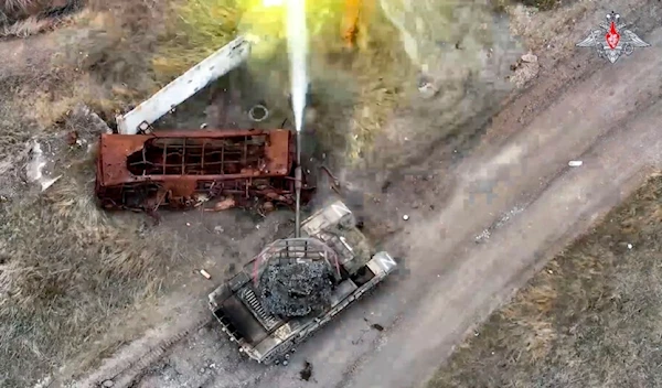 In this photo taken from video and released by the Russian Defense Ministry Press Service on Monday, April 8, 2024, a Russian tank fires towards an Ukrainian position in an undisclosed location (Russian Defense Ministry Press Service via AP)