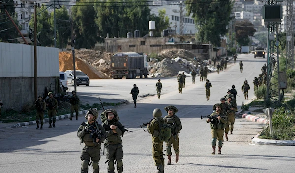 Israeli occupation forces are seen in Balata, a Palestinian refugee camp in Nablus, West Bank, November 23, 2023 (AP)