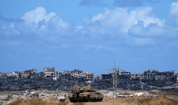 An Israeli tank overlooks the Gaza Strip, as seen from southern 'Israel', on May 6, 2024. (AP)