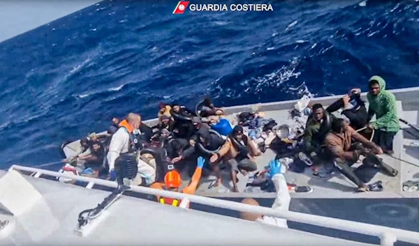 In this image from a video released by Italian Coast Guard on Thursday, April 11, 2024, a boat with migrants is approached by a rescue operation off the island of Lampedusa, Mediterranean Sea. (AP)