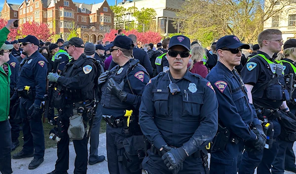 Police gather as they start removing tents erected by protesters from the campus of the University of Wisconsin in Madison on Wednesday, May 1, 2024, in Madison, Wis. Campus. (AP)