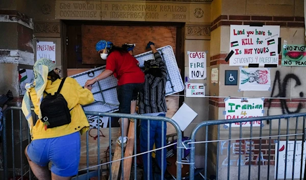 Demonstrators block the entrance to a building on the UCLA campus, after clashes between Pro-'Israel' and Pro-Palestinian groups, Wednesday, May 1, 2024, in Los Angeles. (AP)