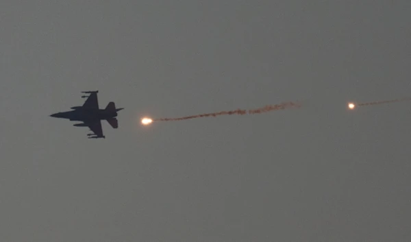 An Israeli fighter jet releases flares as it flies over the Gaza Strip, Tuesday, Jan. 16, 2024. (AP)