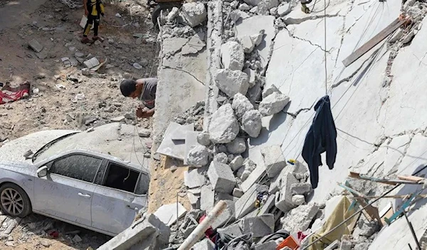 A Palestinian looking for survivors under residential building that was destroyed during Israeli bombardment at the Al-Daraj neighborhood in Gaza City on May 20. (AFP)