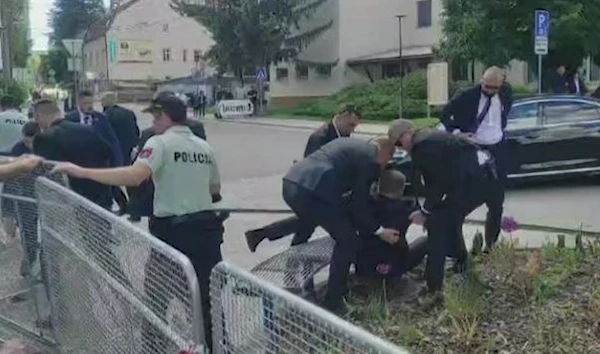 This image taken from video footage obtained by AFPTV shows security personnel carrying Slovakia's Prime Minister Robert Fico (C) toward a vehicle after he was shot in Handlova on May 15, 2024. (RTVS/AFP via Getty Images)