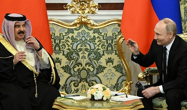 Russian President Vladimir Putin, right, and Bahrain's Crown Prince and Prime Minister Salman bin Hamad bin Isa Al Khalifa gesture during their meeting at the Kremlin in Moscow, Russia, Thursday May 23, 2024. (AP)