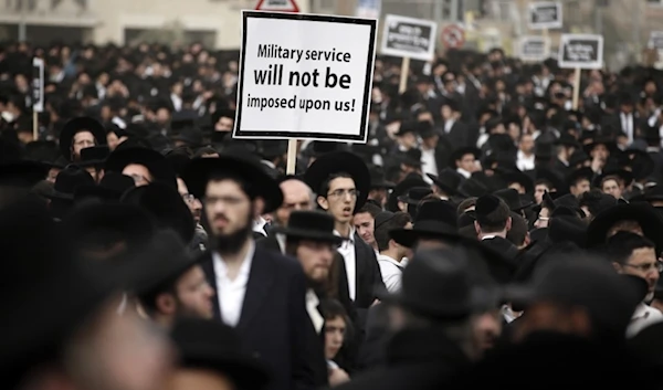 Haredi Jews burn Israeli flag outside recruitment center in 'Tel Aviv'