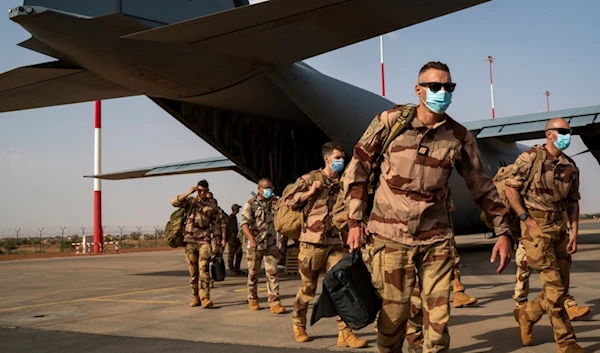 French soldiers disembark from a U.S. Air Force C130 cargo plane at Niamey, Niger base, on June 9, 2021 (AP)