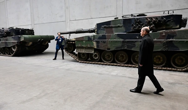 German Chancellor Olaf Scholz visits a production line at the future site of an arms factory where weapons maker Rheinmetall plans to produce artilleries from 2025, in Unterluess, Germany, Monday Feb. 12, 2024 (AP)