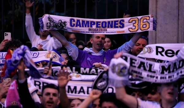 Real Madrid supporters celebrate in Cibeles Square in Madrid after their team clinched the La Liga title, Saturday, May 4, 2024 (AP)