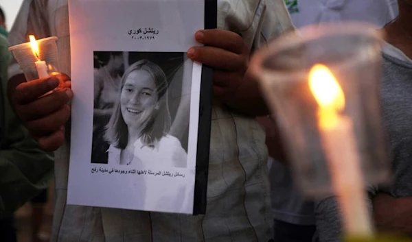 Palestinian children hold candles during a rally at a refugee camp in Rafah, in the southern Gaza Strip, in 2012, in memory of Rachel Corrie. (AFP)