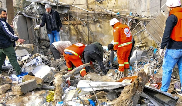 Medical workers inspect the site of the Israeli airstrike in Hebbariyeh. (AFP/Getty Images)