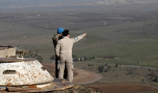 Illustrative: United Nations personnel stand at a lookout point as they monitor the Lebanese border with the occupied Golan Heights, on Jan. 21, 2019. (AFP/GETTY IMAGES)