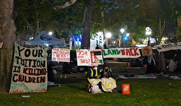 People stand guard outside an encampment set up by pro-Palestinian demonstrators on the campus at the University of Southern California Saturday, May 4, 2024, in Los Angeles. (AP)