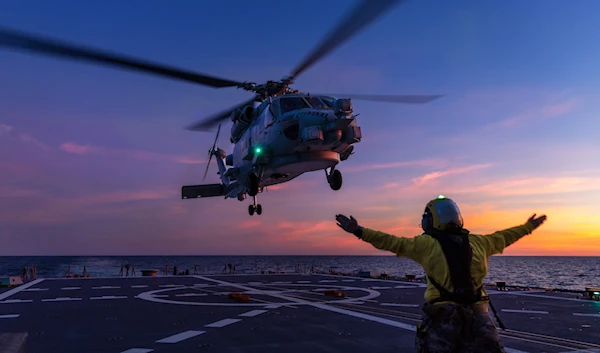 a Seahawk helicopter prepares to land on the deck of HMAS Hobart during flying operations while on a regional presence deployment off northern Australia (Australian Defence Force via AP)