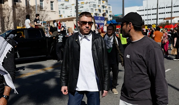 U.S. rapper Macklemore, center, attends a demonstration in support of Palestinians calling for a ceasefire in Gaza on March 10, 2024, in the Hollywood section of Los Angeles. (AP)