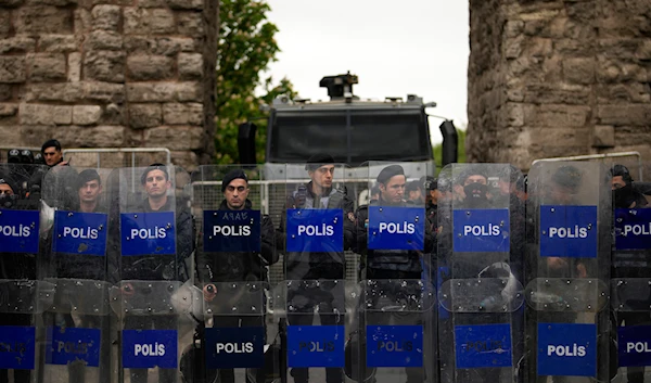 Anti riot police officers stand guard blocking the route to protesters as Union members march during Labor Day celebrations in Istanbul, Turkey, Wednesday, May 1, 2024. (AP)