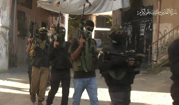 A screenshot from the video showing members of the Tulkarm Brigade walking in the refugee camp on May 2, 2024. (military media)