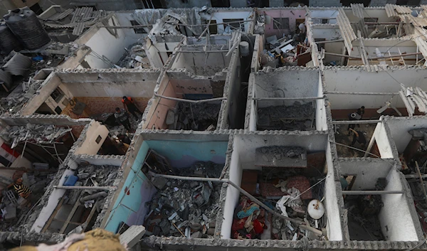 Palestinians look at the destruction caused by an Israeli strike on a residential building in Rafah, Gaza Strip, Tuesday, May 7, 2024. (AP)