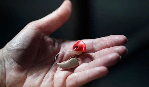 A woman holds her hearing aid on Friday, April 15, 2022, in Salt Lake City.(AP)