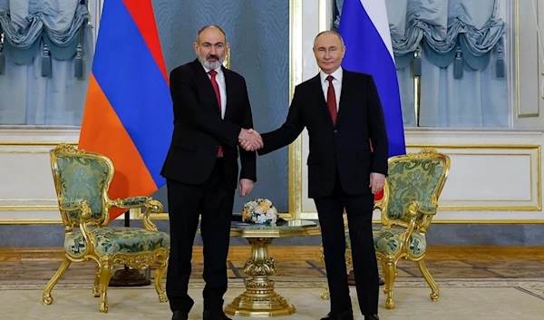 Russian President Vladimir Putin, right, and Armenian Prime Minister Nikol Pashinyan shake hands prior to their talks on the sidelines of a meeting of the Eurasian Economic Union at the Kremlin in Moscow, Russia, on Wednesday, May 8, 2024.(AP)