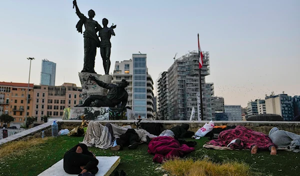 People sleep in Beirut's Martyrs' square after fleeing the Israeli airstrikes in Beirut's southern suburb, Lebanon, on September 30, 2024. (AP)