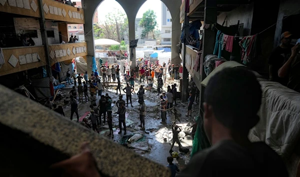 Palestinians inspect the damage of a school hit by an Israeli bombardment on Deir al-Balah, central Gaza Strip, Thursday, Oct. 10, 2024. (AP Photo/Abdel Kareem Hana)