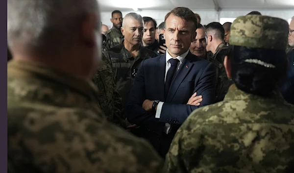 French President Emmanuel Macron speaks with Ukrainian soldiers in a military camp in eastern France, October 9, 2024. (AP)