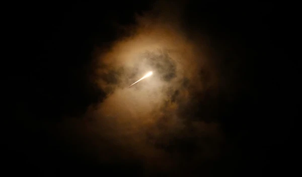 FILE - Projectiles fly through the sky in central occupied Palestine as a siren sounds a warning of incoming missiles fired from Iran towards "Israel", Oct. 1, 2024. (AP Photo/Ohad Zwigenberg, File)