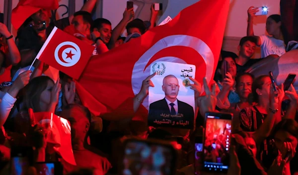 Supporters of Tunisian president and candidate for re-election Kais Saied celebrate after the announcement of the provisional results for the presidential elections, in the capital Tunis, Tunisia, Sunday, Oct. 6, 2024. (AP)