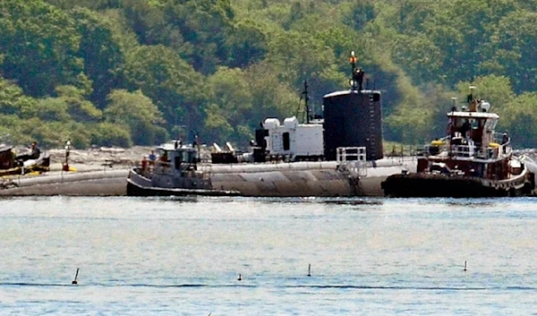 In this Friday, June 12, 2015 photo provided by the U.S. Navy, tugs assist as the former USS Miami nuclear-powered submarine is towed from the Portsmouth Nasal Shipyard in Kittery, Maine. (AP)