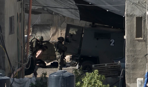 The Israeli army arrest a Palestinian man in the West Bank town of Qabatiya during a raid, on September 19, 2024. (AP)