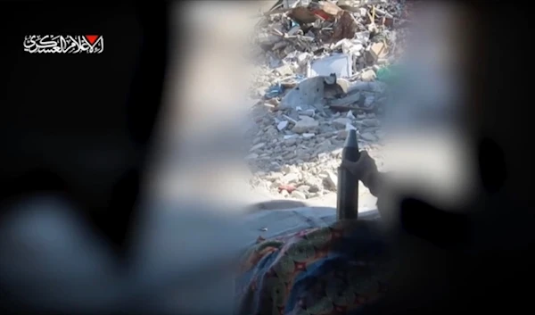 An al-Qassam Brigades fighter loads a mortar shell to be fired at the Israeli occupation forces in Jabalia, northern Gaza, occupied Palestine, on October 12, 2024 (al-Qassam Military Media)