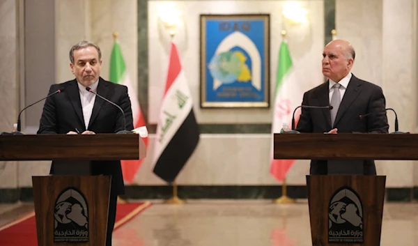 Iranian Foreign Minister Abbas Araghchi (L) and his Iraqi counterpart Fuad Hussein attend a joint press conference in Baghdad on October 13, 2024. (Photo by AFP)