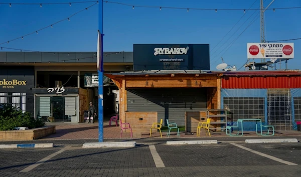 A man walks past closed business due to the war on Gaza, in "Sderot", occupied Palestine, Sunday, Feb. 11, 2024. (AP)