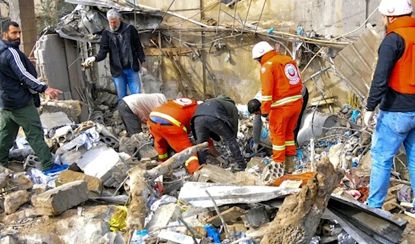 Medical workers inspect the site of the Israeli airstrike in Hebbariyeh in March. (AFP via Getty Images)