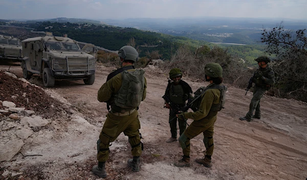 Israeli soldiers are seen during a ground operation in southern Lebanon, near the border with occupied Palestine, on October 13, 2024. (AP)