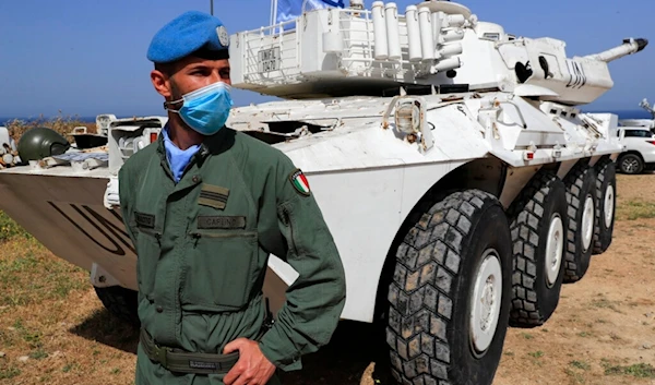 An Italian UN peacekeeper soldier stands guard at a road that links to a United Nations Interim Force In Lebanon (UNIFIL) in Naqoura, Lebanon, Tuesday, May 4, 2021 (AP)