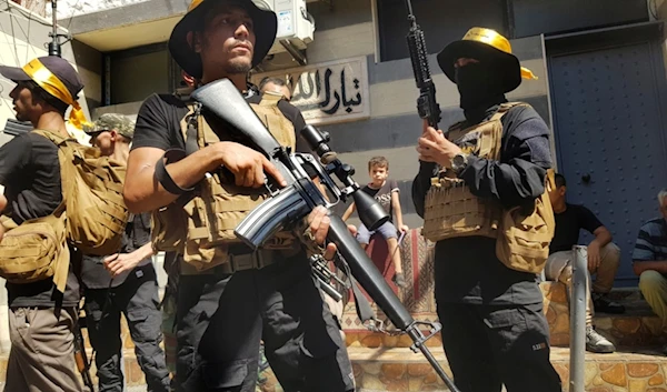 Palestinian Fatah fighters from Al-Aqsa Martyrs' Brigades, stand guard during the funeral procession of Khalil al-Maqdah, Aug. 21, 2024. (AP)