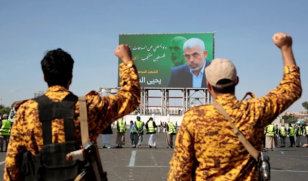 Yemeni soldiers shout slogans in front of a billboard showing martyred Hamas leader Yahya Sinwar during an anti-Israeli rally in Sanaa, Yemen, Friday, October 18, 2024  (AP)