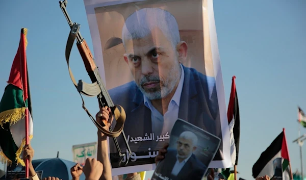 Yemenis raise a poster of martyred Hamas leader Yahya Sinwar during an anti-Israeli rally in Sanaa, Yemen, Friday, October 18, 2024 (AP)