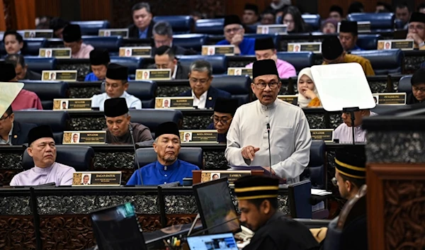 In this photo released by Malaysia's Department of Information, Malaysia's Prime Minister and Finance Minister Anwar Ibrahim, right, delivers the 2025 budget speech at parliament in Kuala Lumpur, Friday, October 18, 2024 (AP)