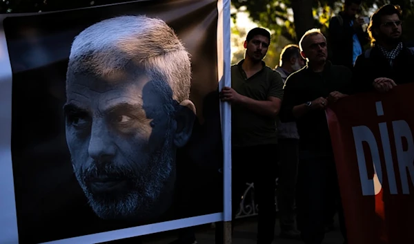 A man holds a banner with a photograph of martyred Hamas leader Yahya Sinwar during a pro-Palestinian protest in Istanbul, Turkey, Saturday, October 19, 2024 (AP)