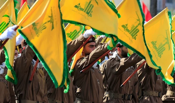 Hezbollah fighters raise their group flags during the funeral a Hezbollah commander and another fighter who were assassinated by an Israeli drone strike, in Chehabiyeh village, south Lebanon, April 17, 2024. (AP)