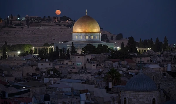 The super moon rises behind the Dome of the Rock shrine at the Al Aqsa Mosque compound in the Old City of al-Quds, Monday, Aug. 19, 2024. (AP)