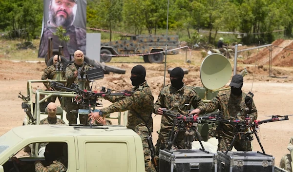 Hezbollah fighters take part in a military exercise with armed drones in Aaramta village in the Jezzine District, southern Lebanon, on May 21, 2023. (AP)